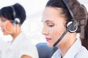 Close-up of a beautiful female executive with headset