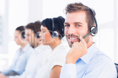 Business colleagues with headsets in a row