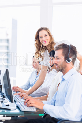 Manager and executives with headsets using computers