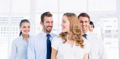 Confident and happy business team together in office