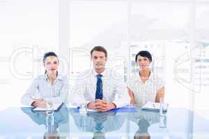 Smartly dressed young executives sitting at desk