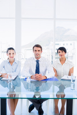 Smartly dressed young executives sitting at desk