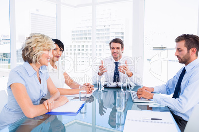 Executives around conference table in office