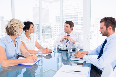 Executives sitting around conference table