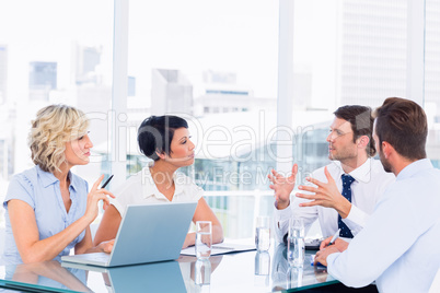 Executives sitting around conference table