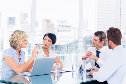 Executives sitting around conference table