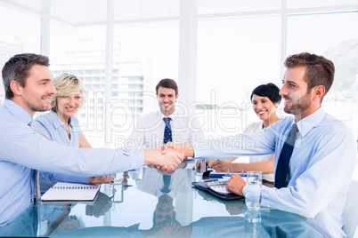 Executives shaking hands during business meeting