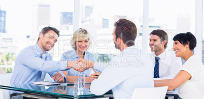 Executives shaking hands during business meeting