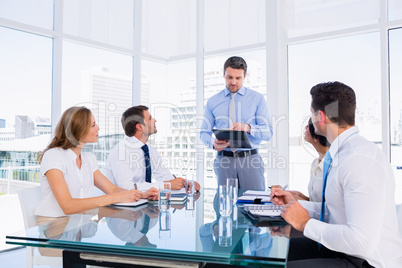 Executives sitting around conference table