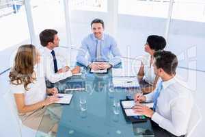 Executives sitting around conference table