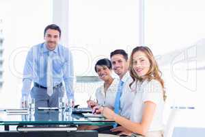 Executives around conference table in office