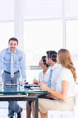 Executives around conference table in office