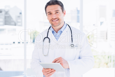 Portrait of a male doctor using digital tablet