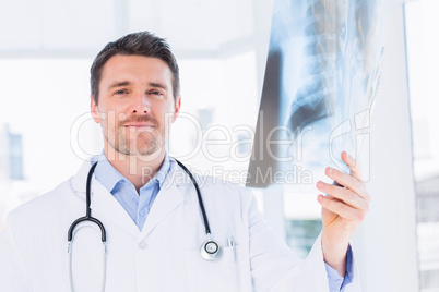 Portrait of a male doctor examining x-ray