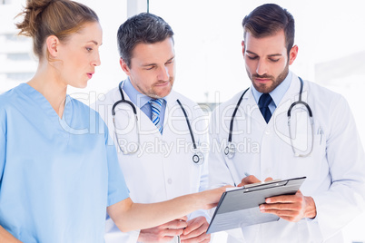 Doctors and surgeon reading medical reports