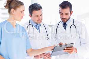 Doctors and surgeon reading medical reports