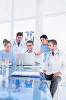 Concentrated medical team using laptop together