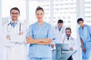 Doctors with colleagues using laptop in medical office