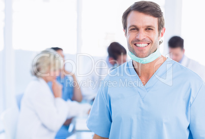 Smiling male surgeon with colleagues in meeting