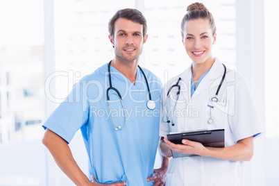 Male surgeon and female doctor with medical reports