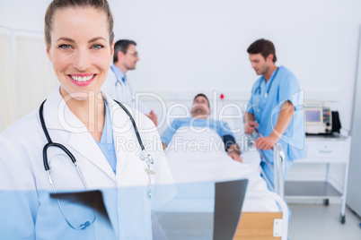 Doctor holding x-ray with surgeons and patient in hospital