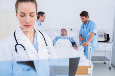 Doctor examining x-ray with surgeons and patient in hospital