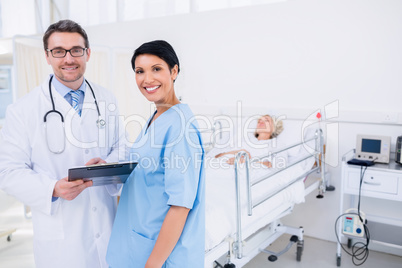 Doctors discussing reports with patient in hospital