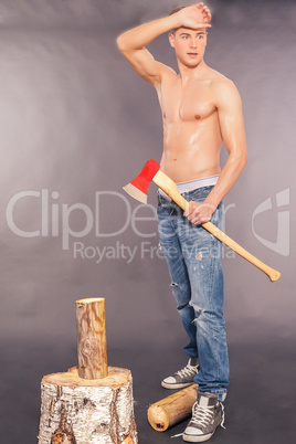 Muskuläre junger Mann hackt Brennholz