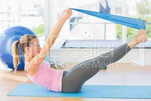 Sporty woman stretching body in fitness studio
