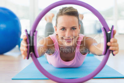 Sporty woman with exercise ring in fitness studio