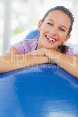 Portrait of a smiling fit woman with exercise ball