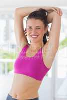 Portrait of a sporty woman stretching hands at yoga class