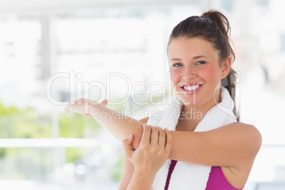 Portrait of a sporty woman stretching hand at yoga class