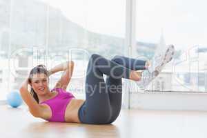 Young woman doing pilate exercises in fitness studio