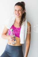 Portrait of a young woman with towel and water bottle