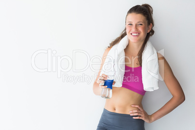 Young woman with towel and water bottle