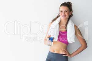 Young woman with towel and water bottle