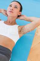 Determined young woman doing abdominal crunches