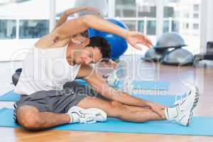 Sporty people stretching hands at yoga class