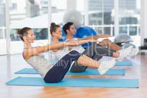 Class stretching on mats at yoga class
