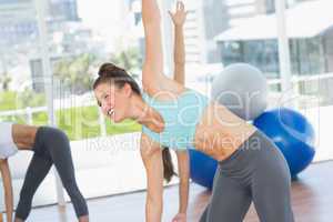 Sporty women stretching hands at yoga class