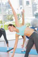 Sporty women stretching hands at yoga class