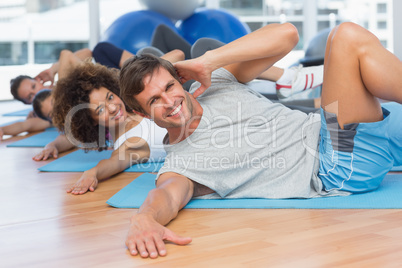 People doing pilate exercises in fitness studio