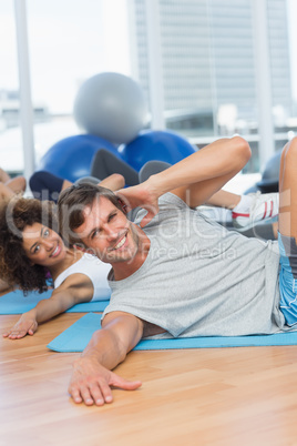 People doing pilate exercises in fitness studio