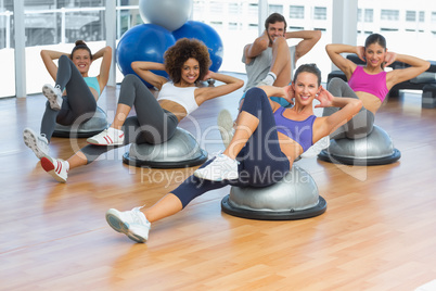 Portrait of cheerful fitness class doing pilates exercise