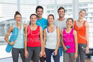 Portrait of fit people smiling in exercise room