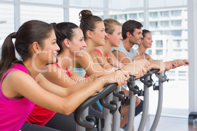 Fit people working out at spinning class