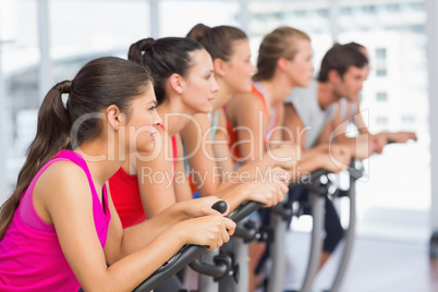 Fit people working out at spinning class