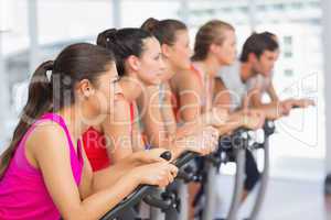 Fit people working out at spinning class