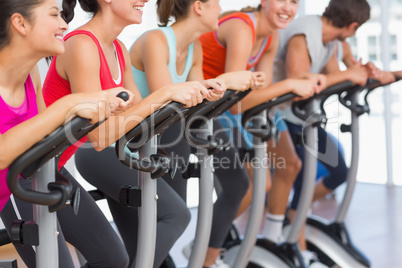 Fit people working out at spinning class